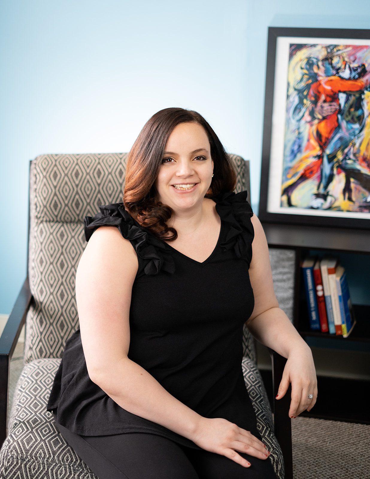 Emily Jones, relationship coach, smiling and seated in an armchair